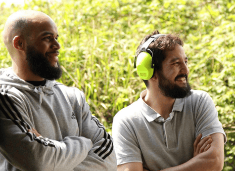 A couple of men wearing headphones

Description automatically generated with low confidence